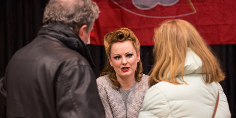 Performer talking to audience member