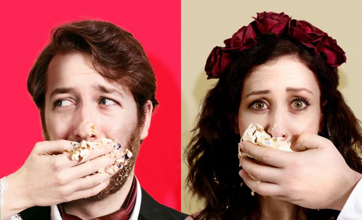Two actors stuffing cake in their mouth