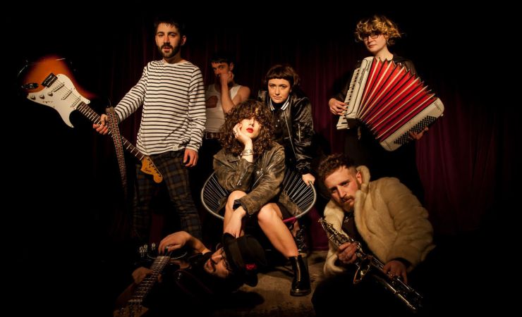 Image of band sitting with instruments