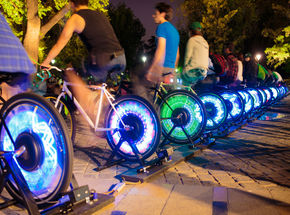 people on light up electric bikes